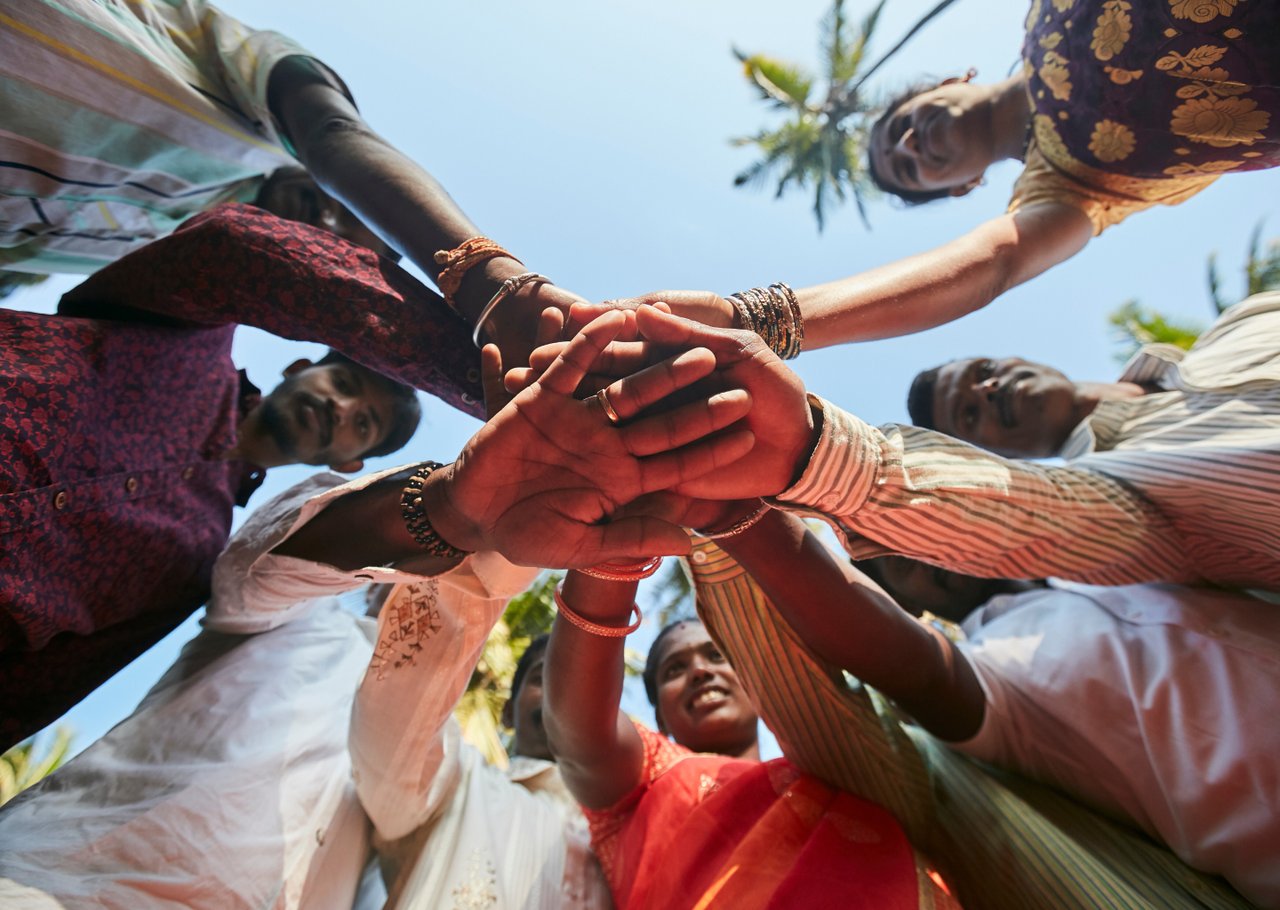 Men and women joining hands