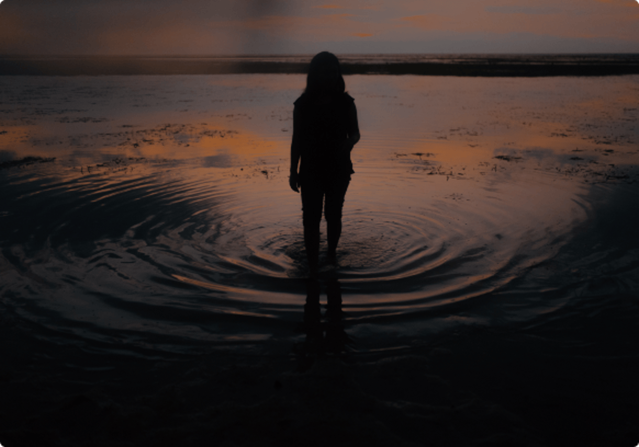 Person at sunset on water